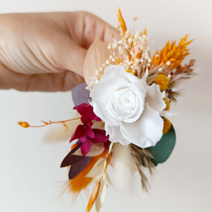 Flatlay of floral wrist corsage in box, perfect for bridesmaids or formal events
