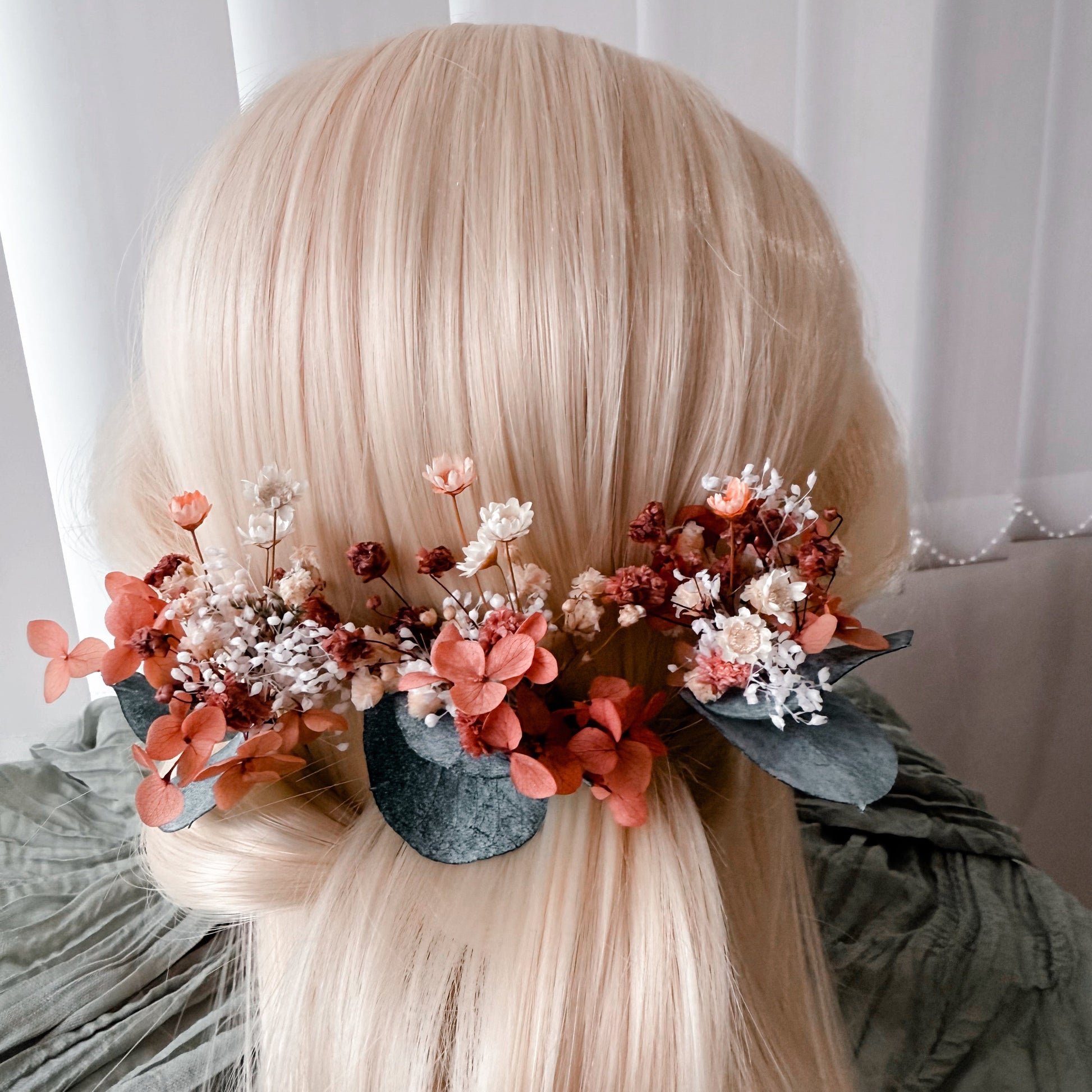 Medium back view of a burnt orange dried flower wedding hairpiece with delicate preserved florals, ideal for boho and rustic bridal looks.