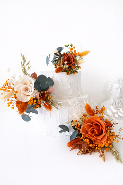 Handmade wedding cake floral decorations in champagne and terracotta tones, arranged with ivory roses, champagne tones and terracotta dried flowers.