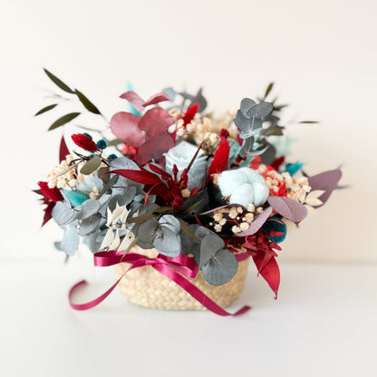 Decorative flower arrangement with red, gray, and green elements on a white background