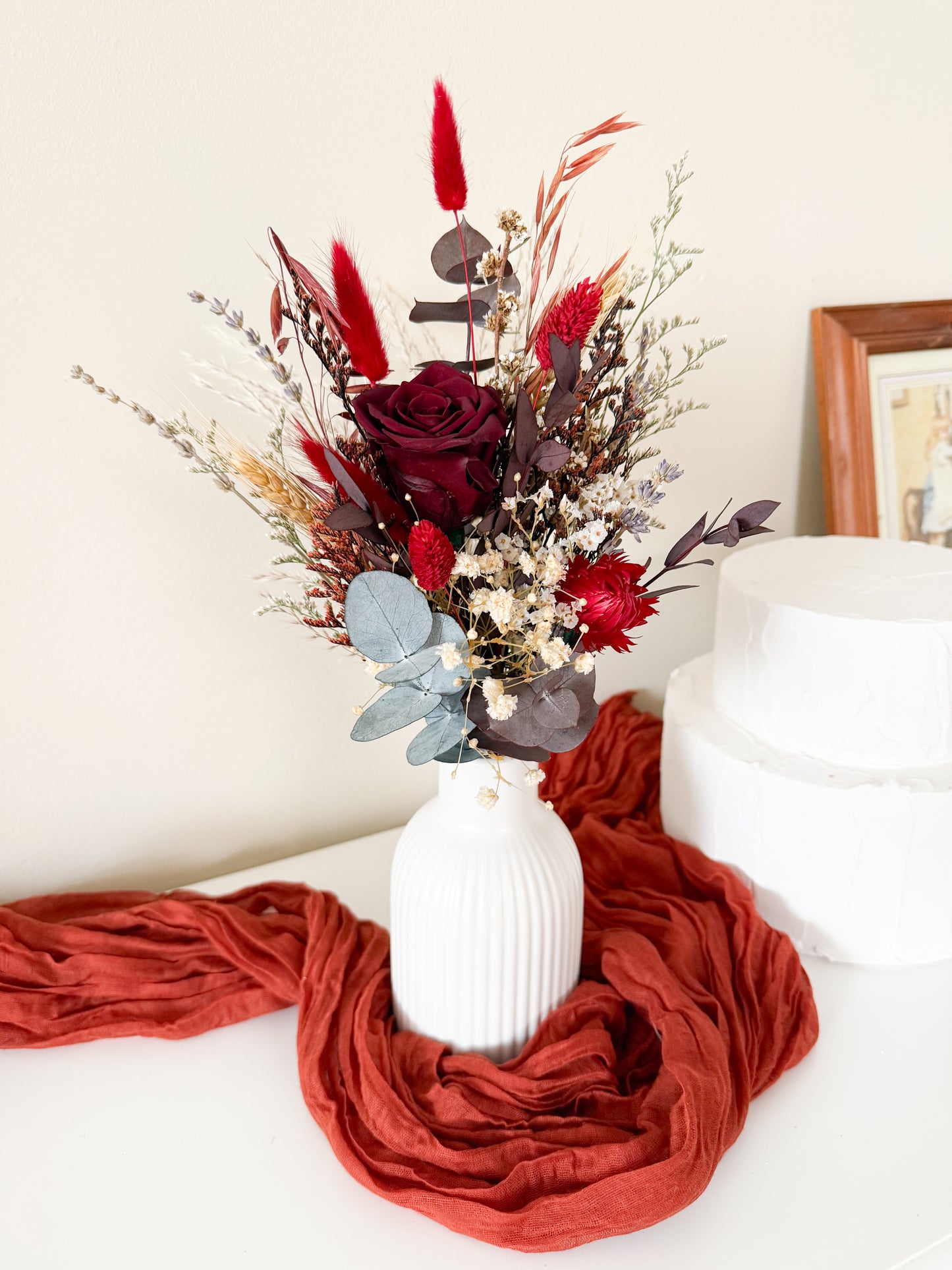  dried floral arrangements with burgundy roses, red preserved flowers, and eucalyptus in matching vases – Australian rustic wedding table centerpieces