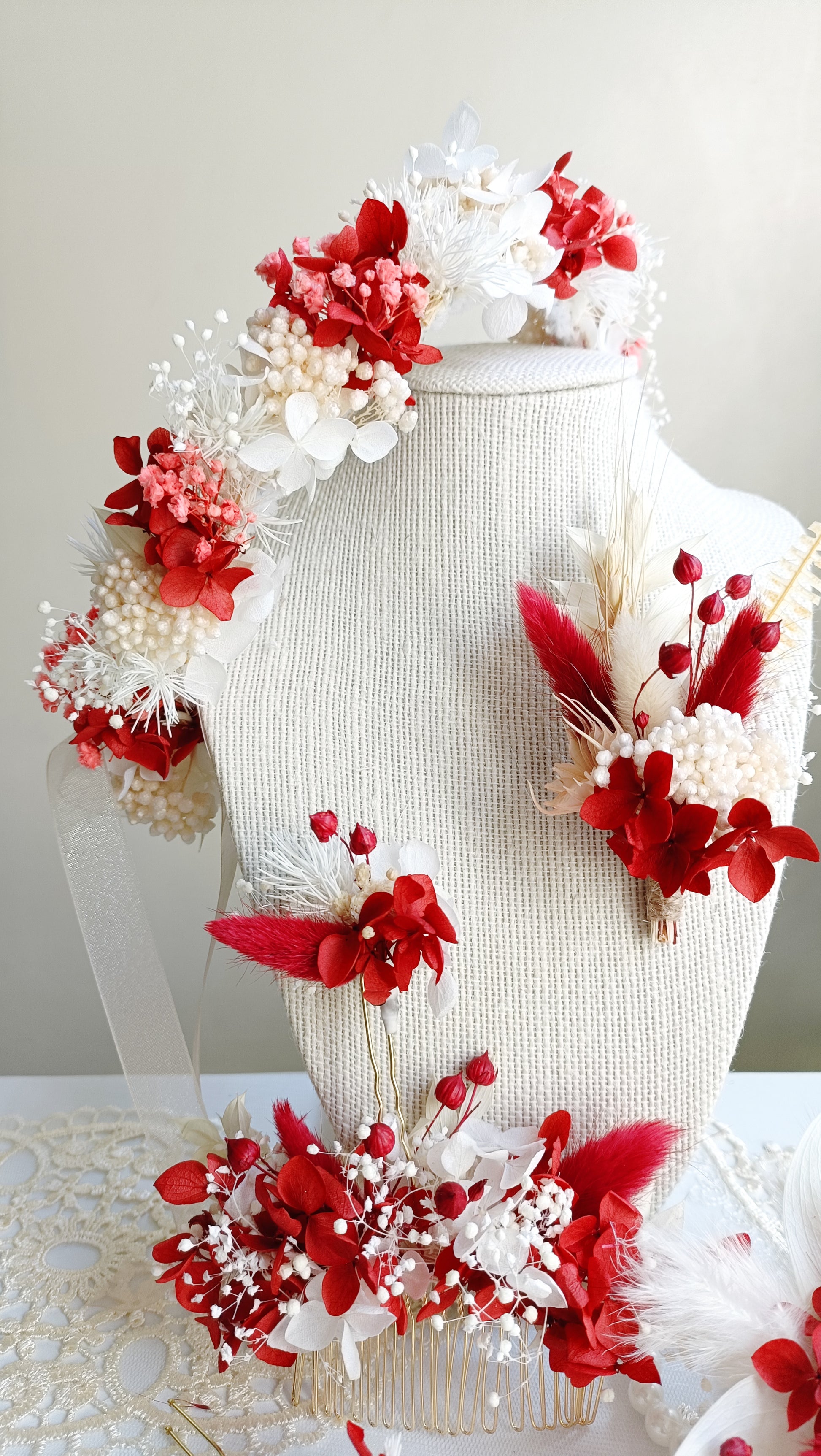 A set of two handcrafted hair clips made from preserved red and white flowers. The clips are detailed with delicate pearl clusters and accented with natural textures for a bohemian feel.