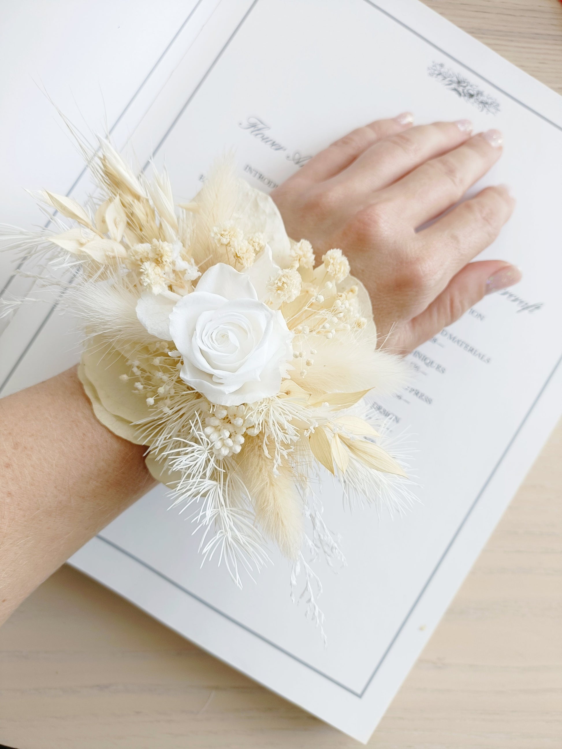 Dried flower wrist corsage with white sola rose, beige bunny tails, preserved grasses, and delicate florals. Handmade neutral dried corsage perfect for bridesmaids, weddings, school formals, or rustic events