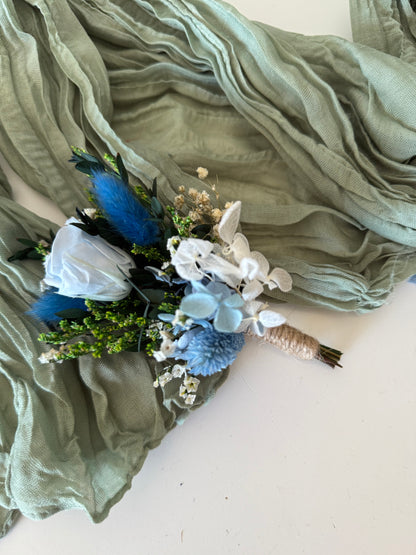 Matching dusty blue boutonniere and bridal bouquet set with sola wood roses and dried flowers for grooms and brides.