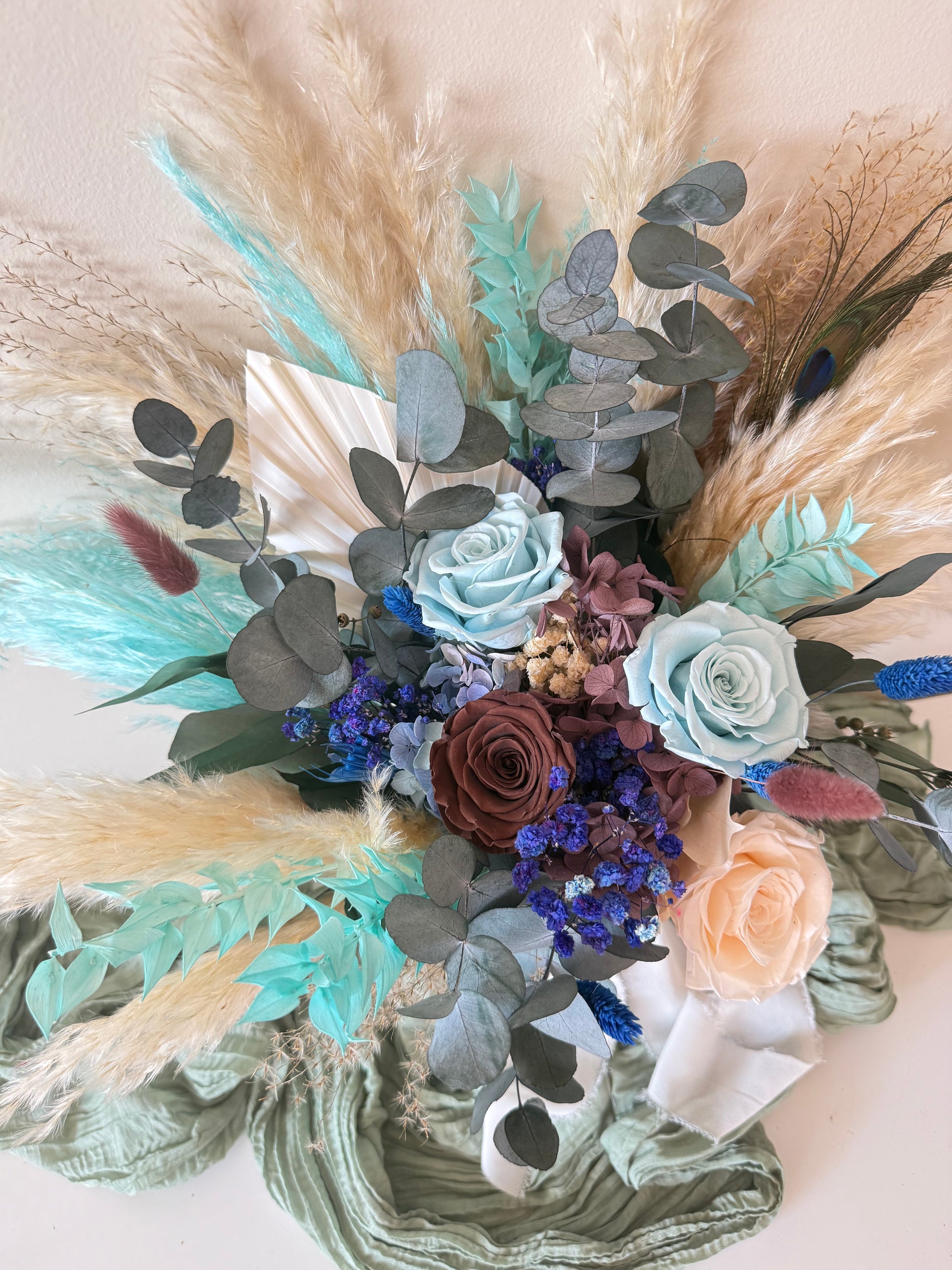 Elegant dried bridal bouquet with teal leaves, beige roses and preserved eucalyptus handmade in Australia.