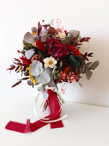 Dried flower rustic bouquet in burgundy, blush and mustard tones with preserved roses, sola flowers and eucalyptus, styled with velvet ribbon