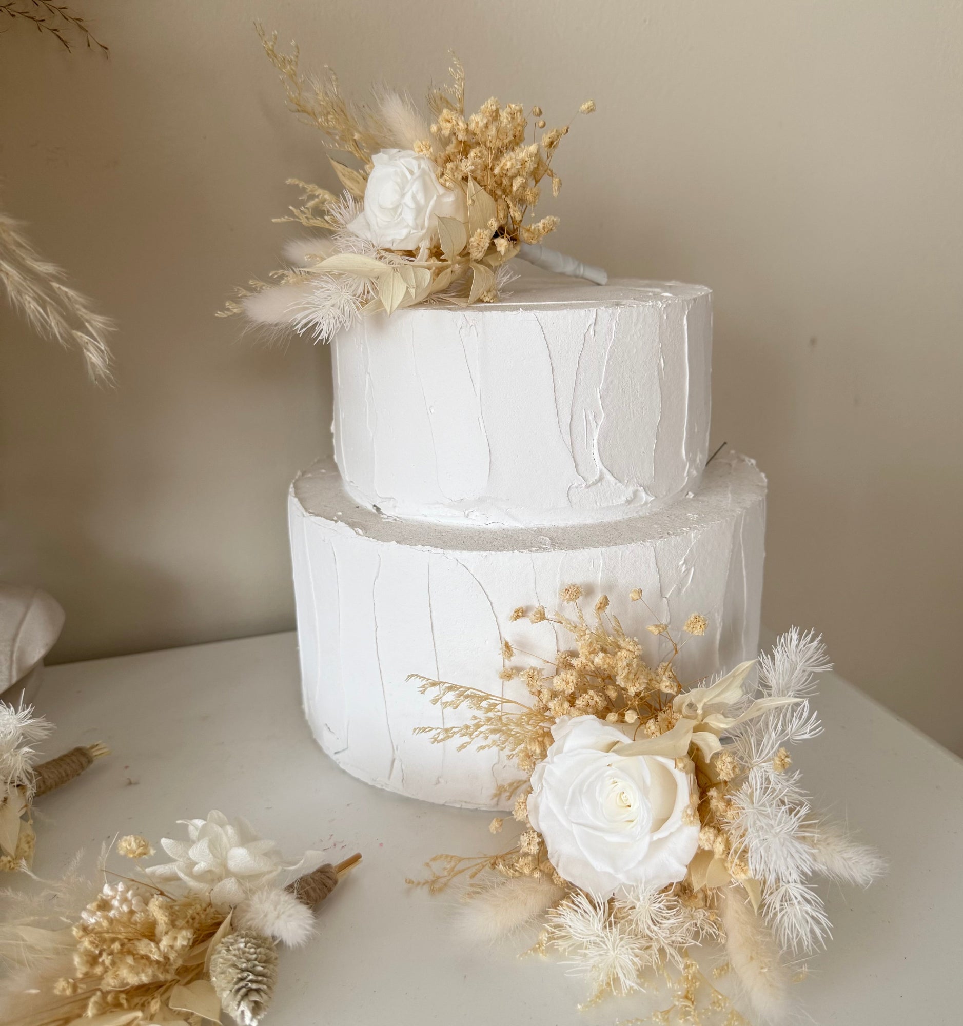 Minimal wedding Cake topper made with sola peonies and dried pampas grass, ideal for modern and elegant bridal looks.