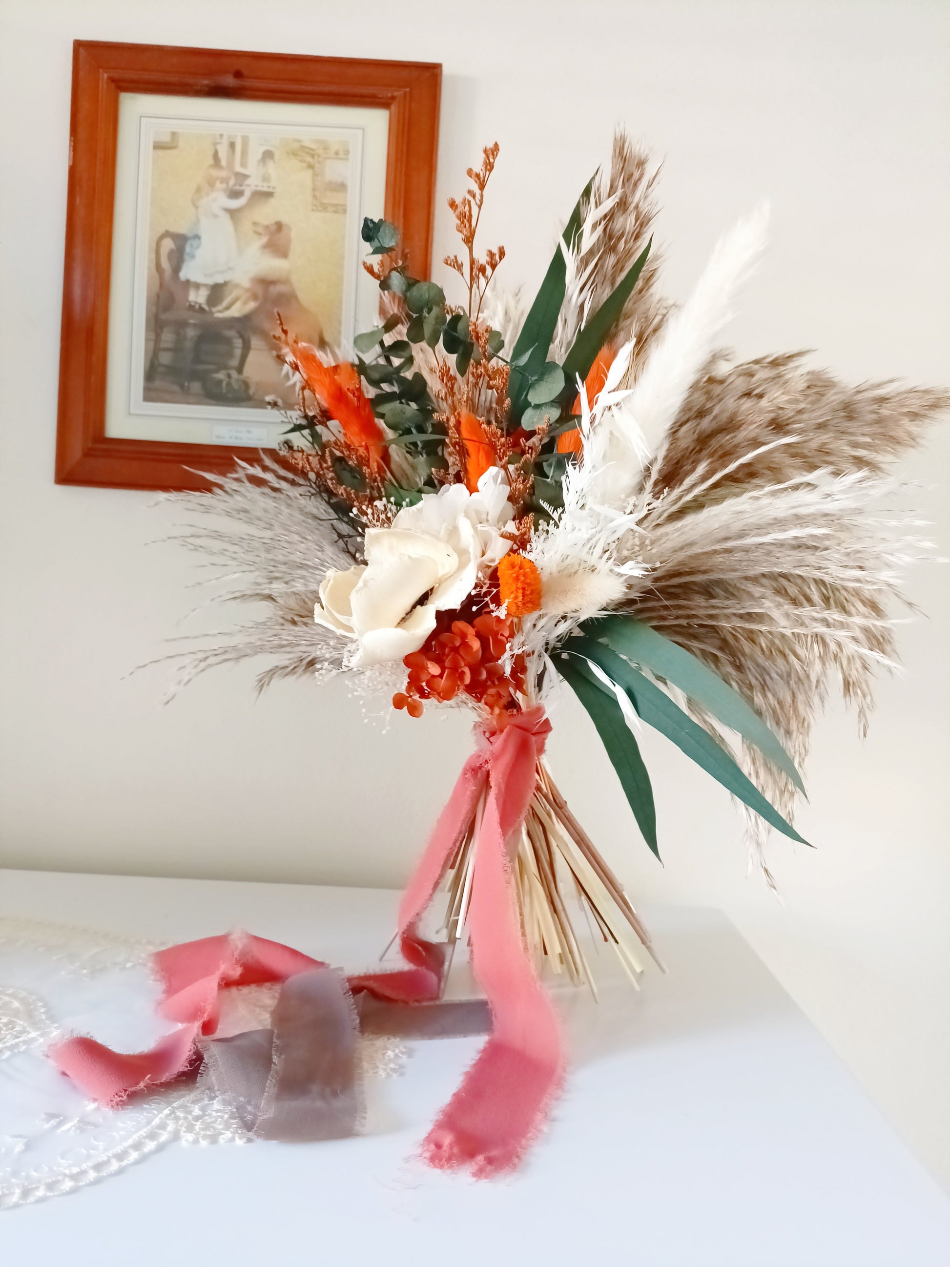 Full view of handmade dried bouquet featuring orange highlights, sola flowers and soft, flowing pampas grass – long-lasting and eco-friendly.
