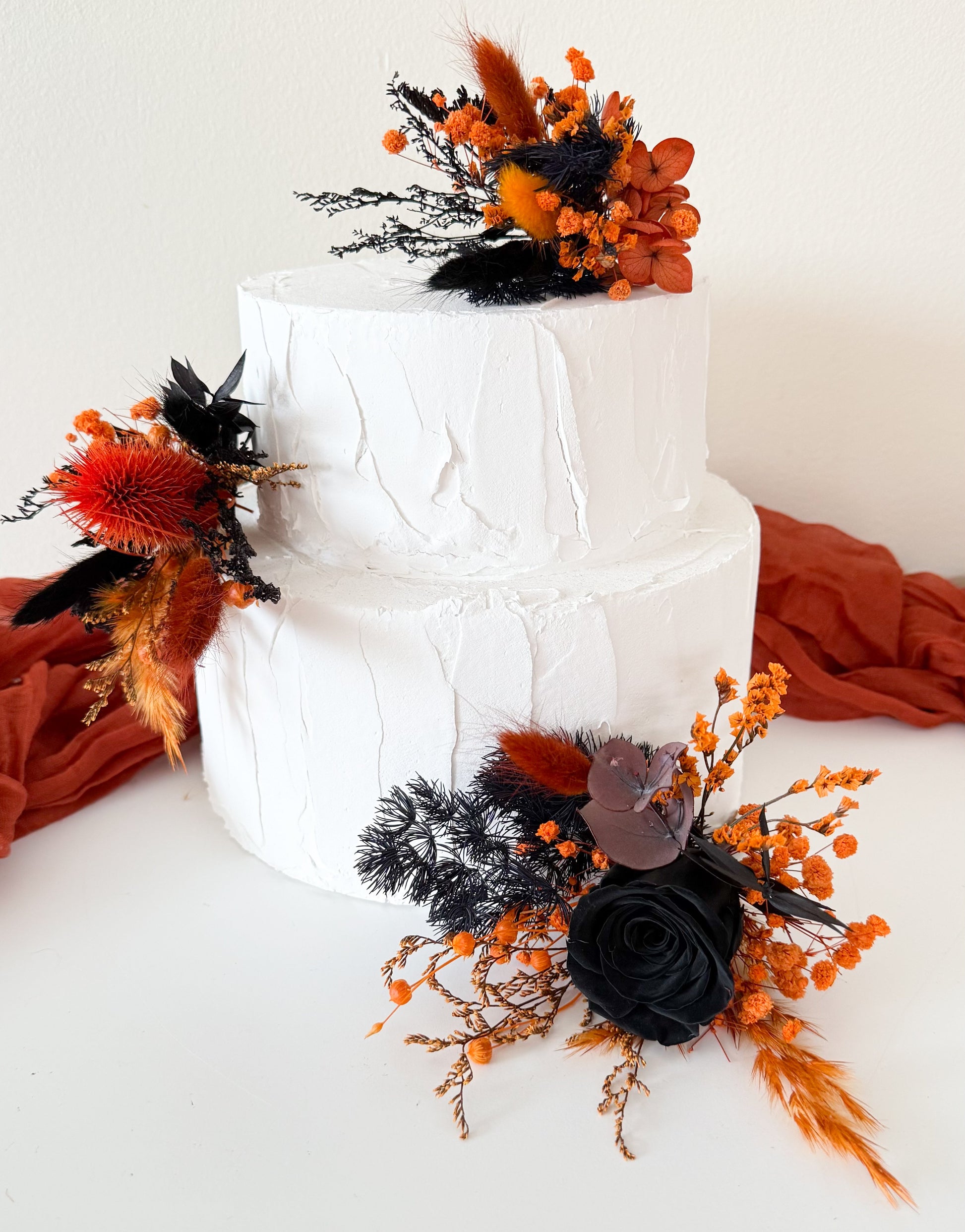 Gothic boho cake decoration made from dried flowers in black and orange tones, handmade in Australia