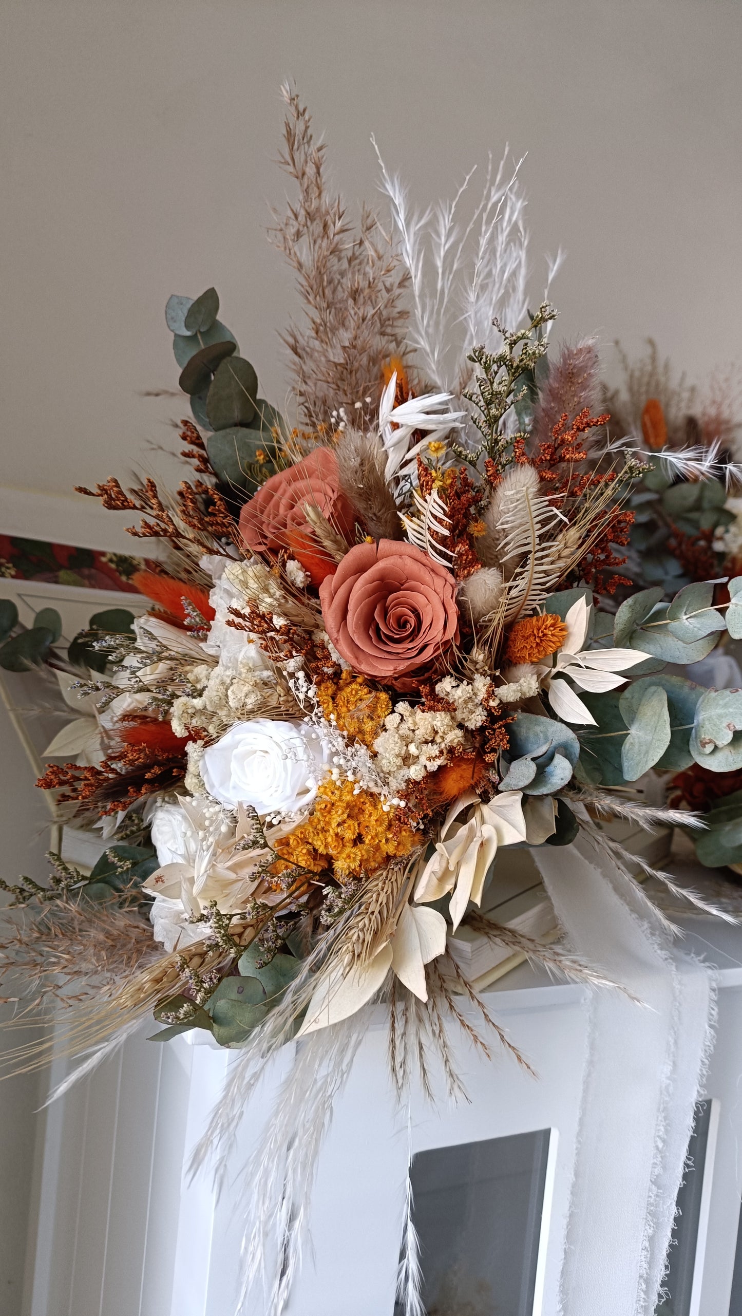 Rustic wedding floral decor featuring dried bouquets and accessories. Each piece is handcrafted with preserved flowers, perfect for a long-lasting, boho-chic celebration