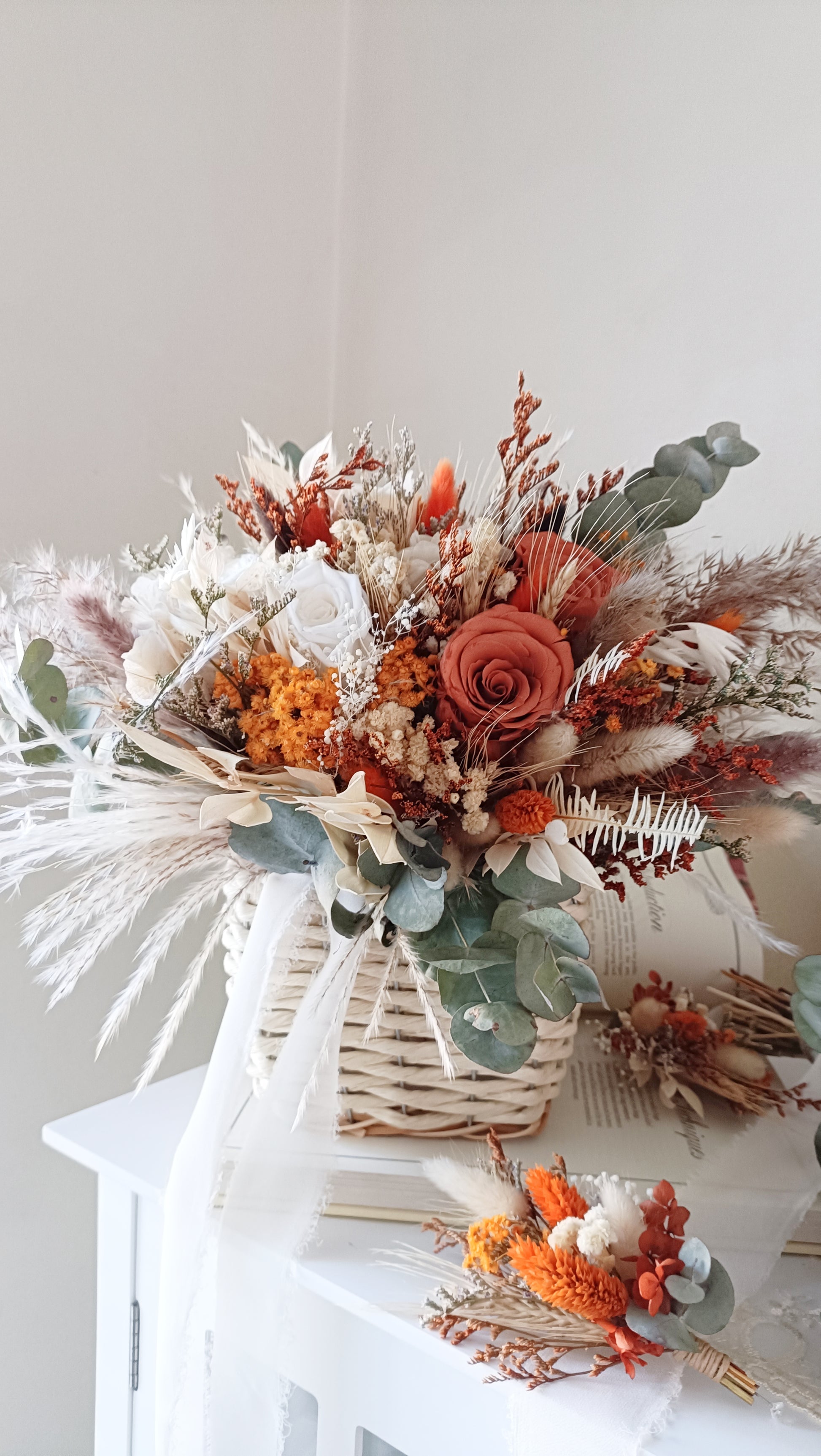 Stunning wedding bouquet made of dried flowers, featuring rustic hues of orange, beige, and green. This handcrafted arrangement includes preserved roses, eucalyptus, pampas grass, and other textural elements, perfect for a boho-chic wedding. Available for custom orders