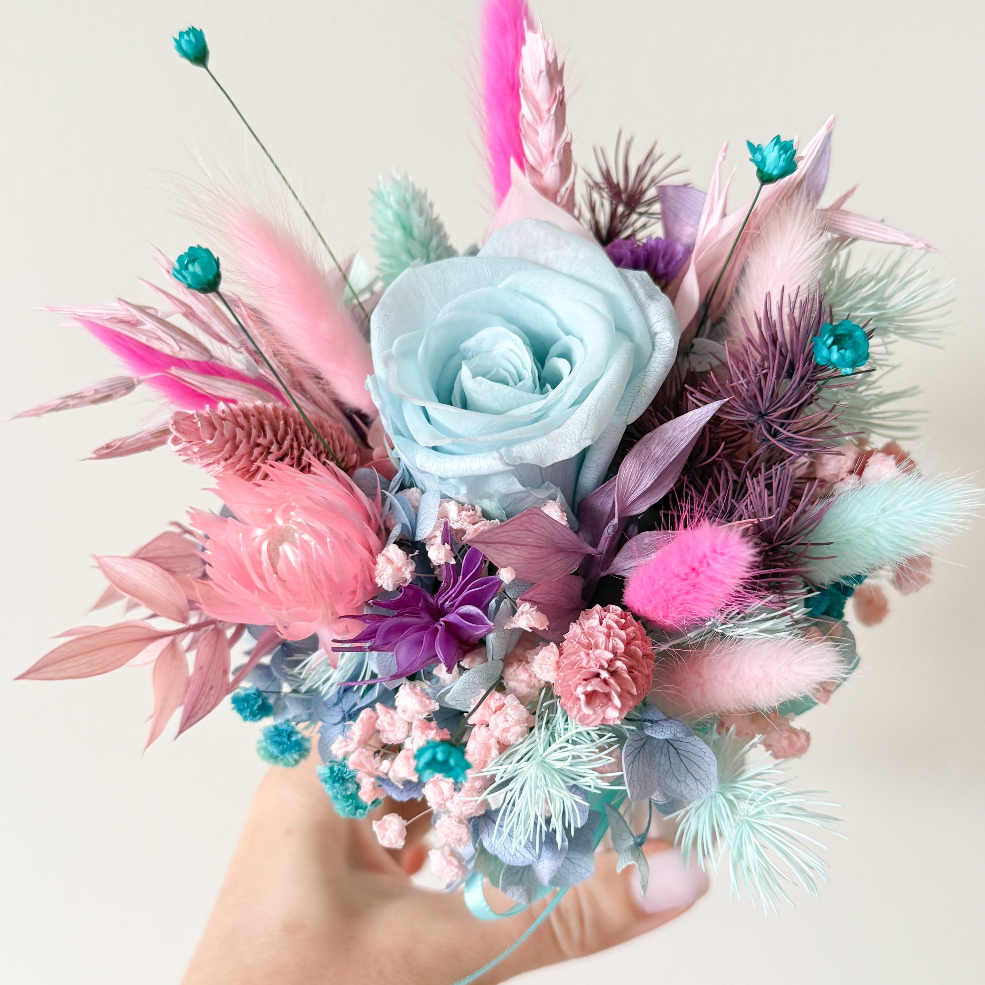 Handmade pastel dried flower centerpiece with turquoise rose and decorative preserved flowers