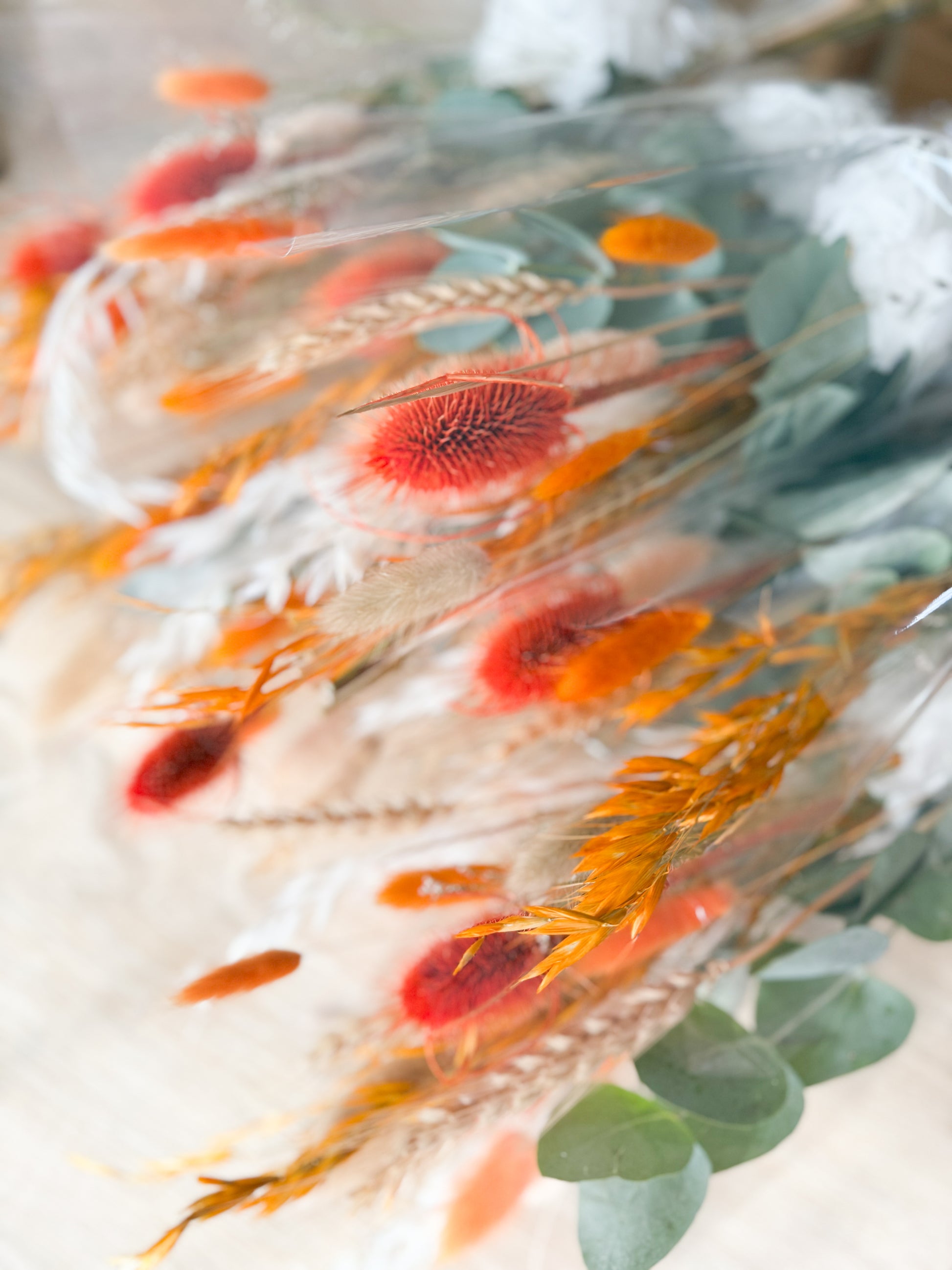 Handmade terracotta and orange dried flower details with preserved hydrangea and eucalyptus leaves
