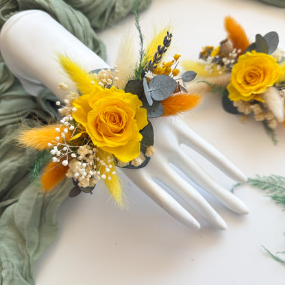 Pair of handmade dried corsages with yellow roses, eucalyptus, and fluffy grasses â€” ideal for rustic or autumn weddings.