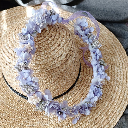 Delicate lavender dried flower crown with preserved hydrangea and ribbon, lightweight bridal floral headpiece displayed on a straw hat