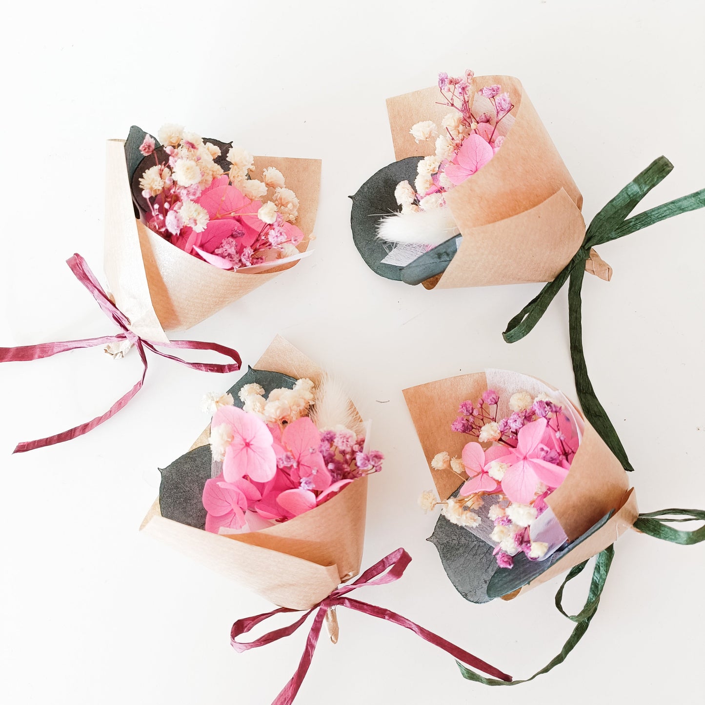 Mini pink dried flower bouquets handmade in Sydney, wrapped in kraft paper and tied with satin ribbons — perfect for wedding favours or bridesmaid gifts.
