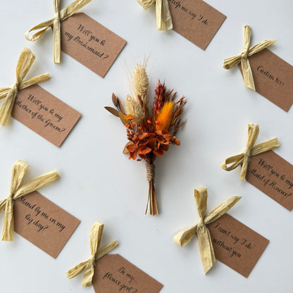 mini Bouquet of dried flowers with brown tags and gold ribbons on a white background