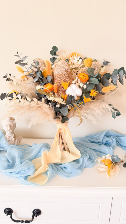 Minimalist boho dried flower bouquet with neutral tones, blue fabric and pampas grass