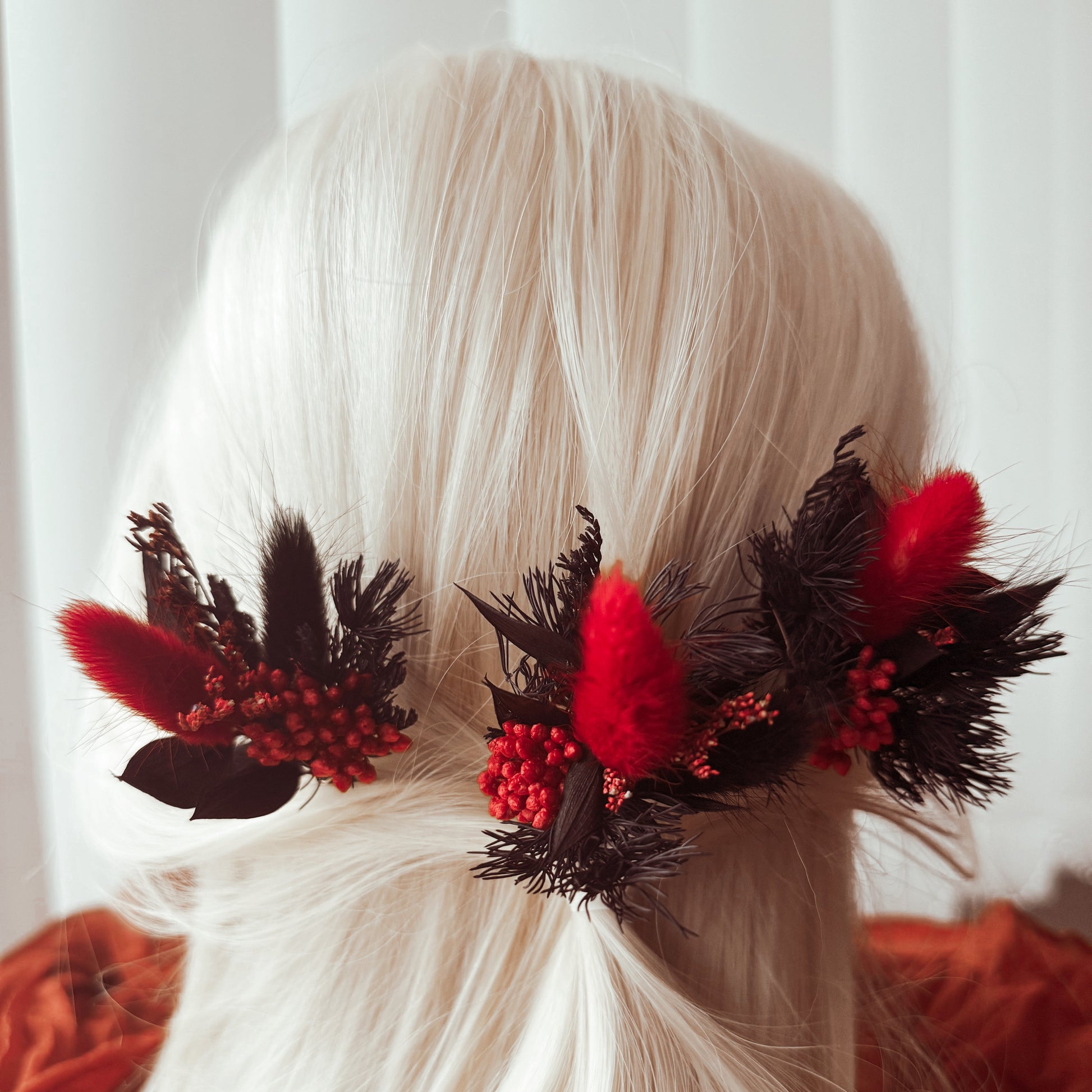 ed and black hair accessories on a white background