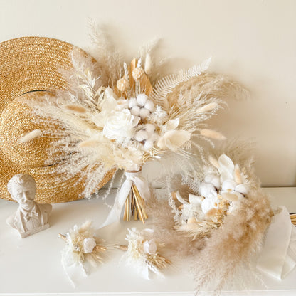 Neutral dried bridal bouquet with ivory preserved rose, cotton bolls and pampas grass in soft beige boho wedding style.