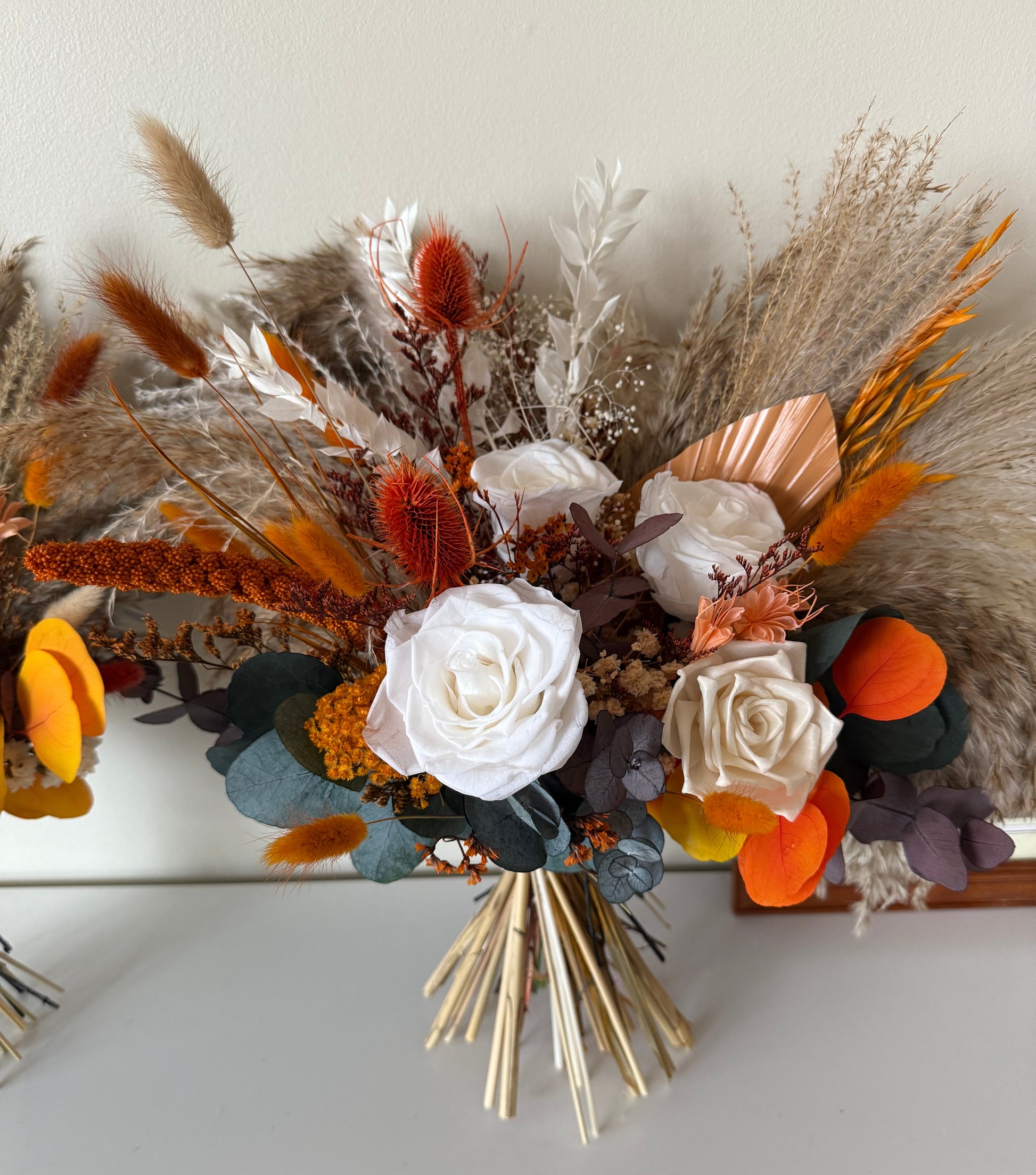 Terracotta and burnt orange dried flower bouquet with pampas, sola wood roses, and rustic foliage — bohemian autumn wedding bouquet.