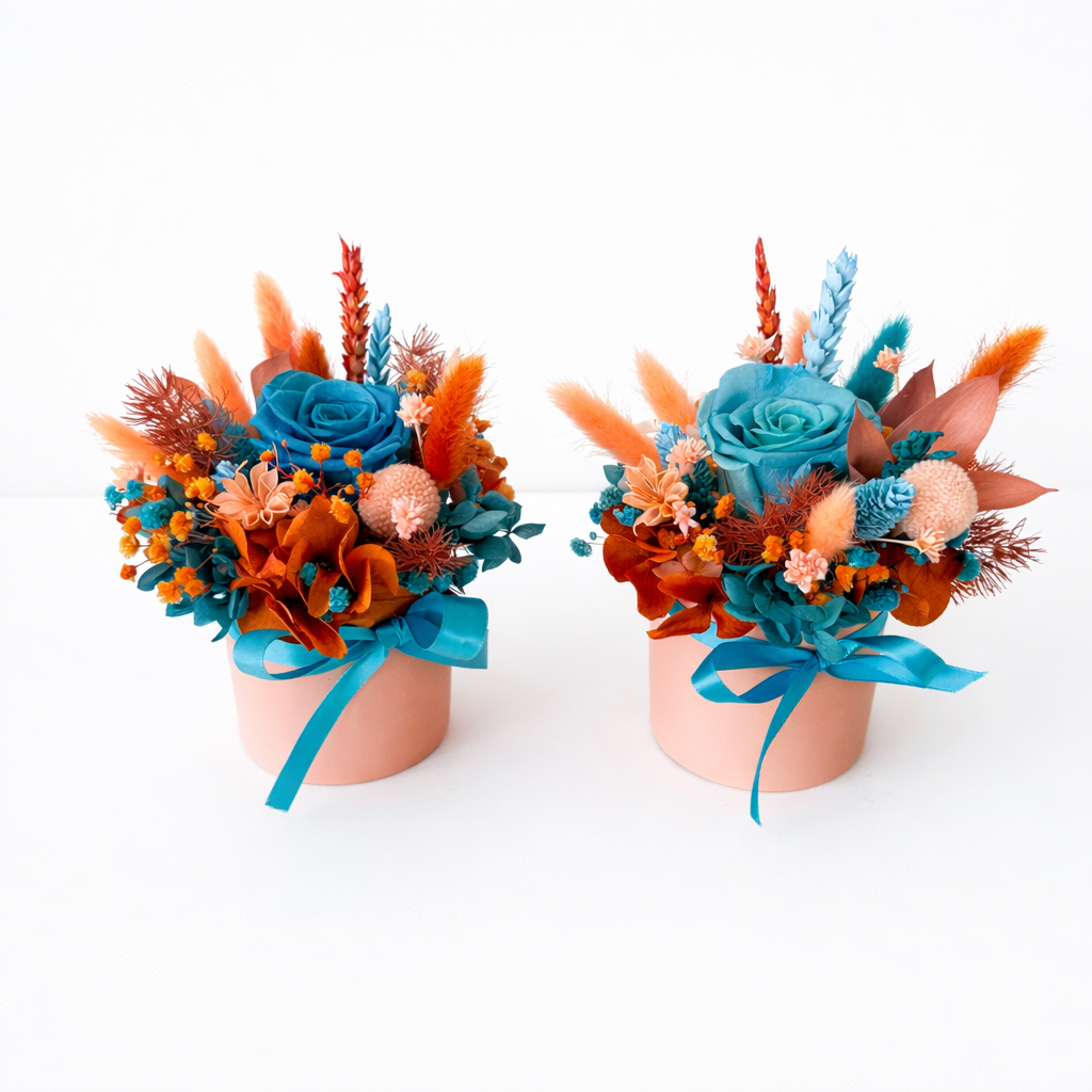 Two handmade preserved flower arrangements with blue roses and dried flowers