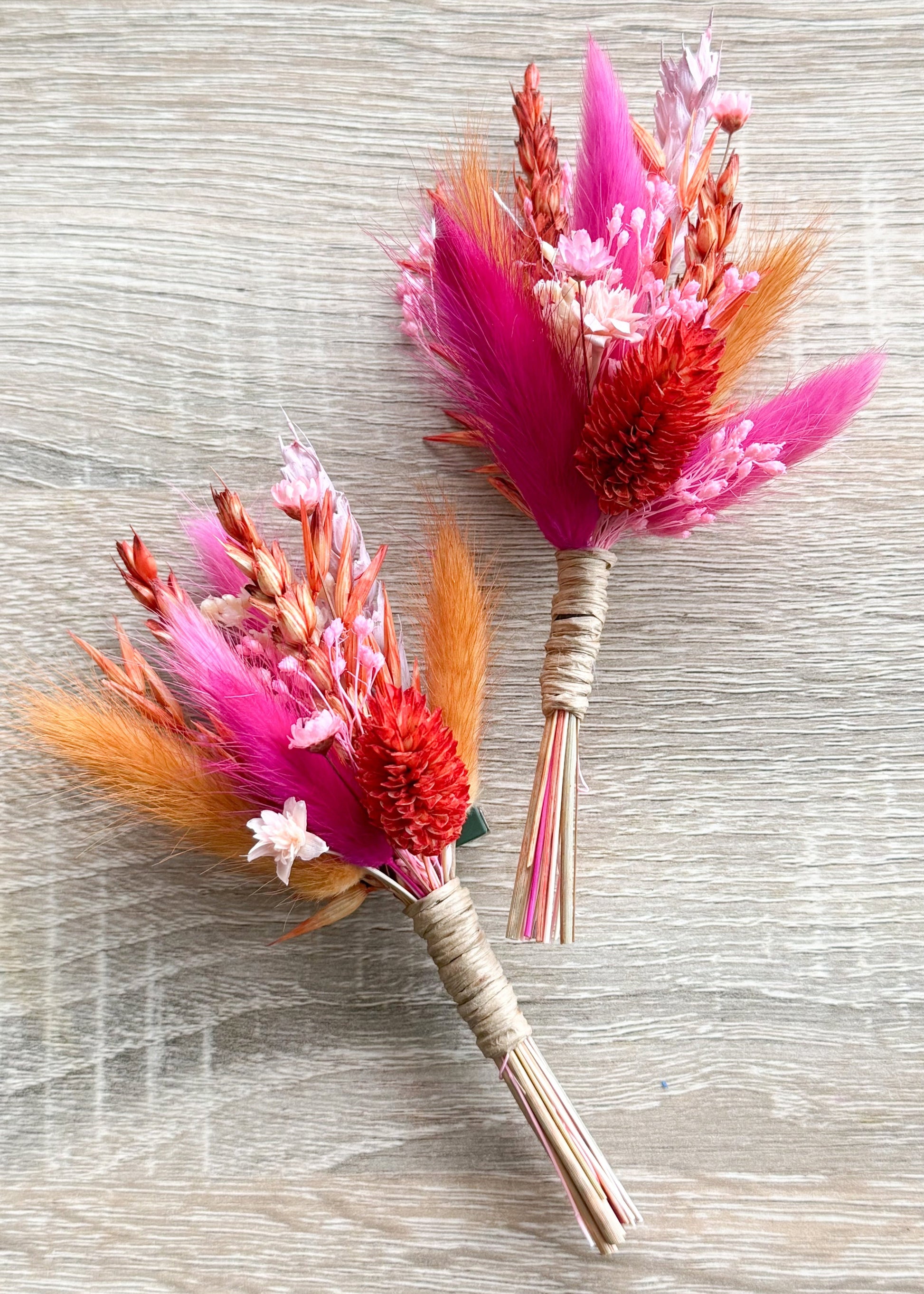 Pink dried flower boutonniere set with preserved grasses, bunny tails and wheat stems on soft pink fabric, handmade wedding boutonniere for groom and groomsmen in Australia