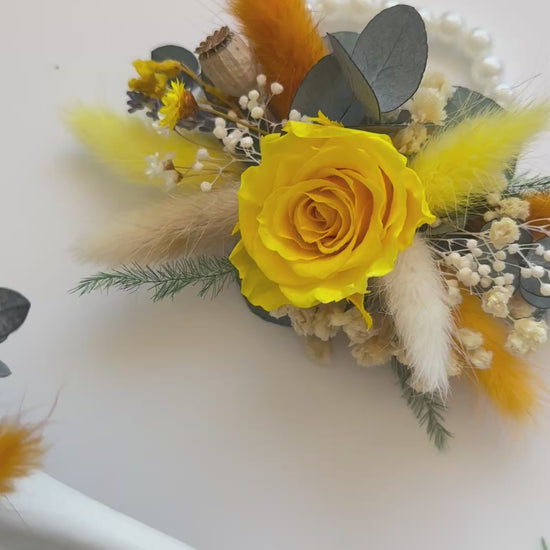 Set of matching yellow dried corsages made with preserved roses, billy buttons, and orange accents — boho rustic wedding style.