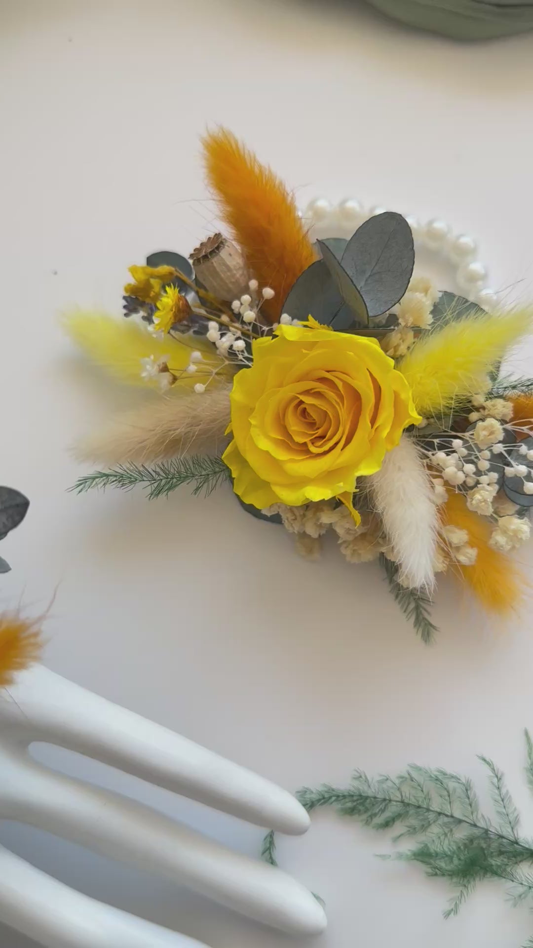 Set of matching yellow dried corsages made with preserved roses, billy buttons, and orange accents — boho rustic wedding style.