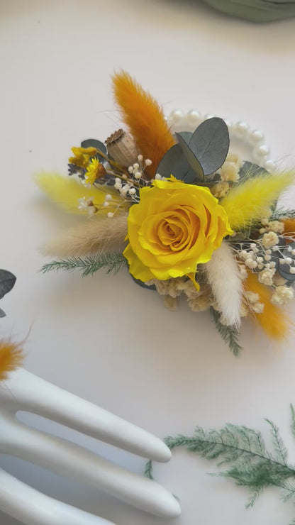 Set of matching yellow dried corsages made with preserved roses, billy buttons, and orange accents — boho rustic wedding style.