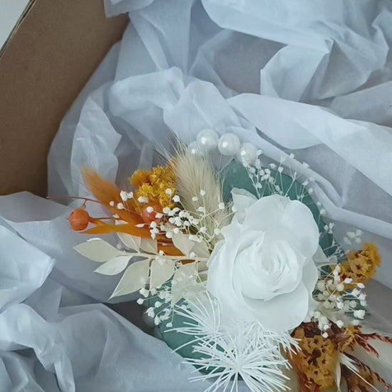 Boho wedding wrist corsage pair in white, mustard, and sage tones with artificial roses and dried florals