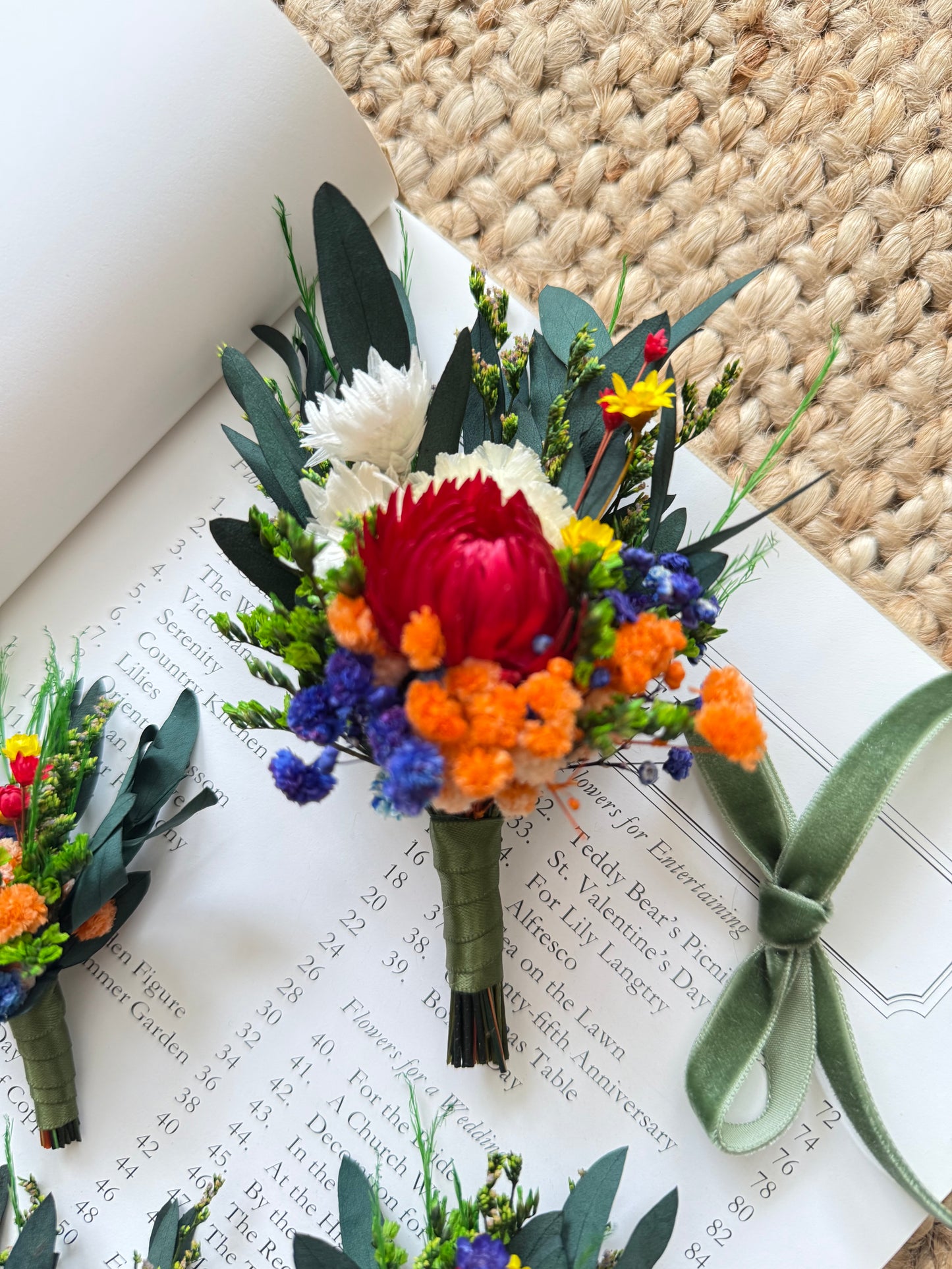 Dried protea boutonniÃ¨re in rich red and orange tones â€“ Australian rustic wedding style