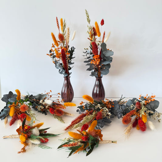 Rust and burnt orange dried wedding flowers with preserved eucalyptus, bud vase arrangements and matching boutonnieres