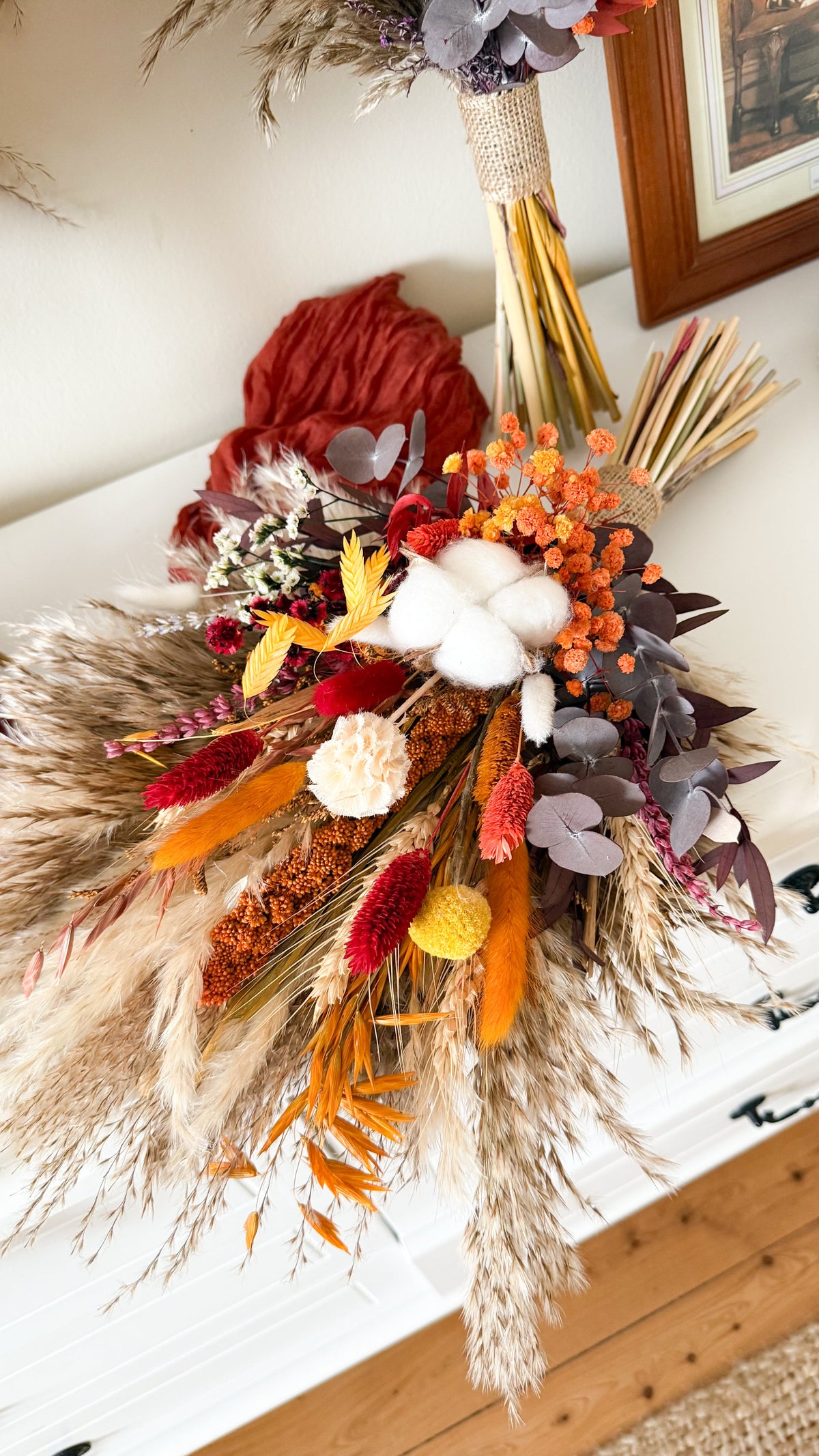Rust and burnt orange dried flower bridal bouquet with cotton, pampas grass, preserved eucalyptus and Australian native flowers
