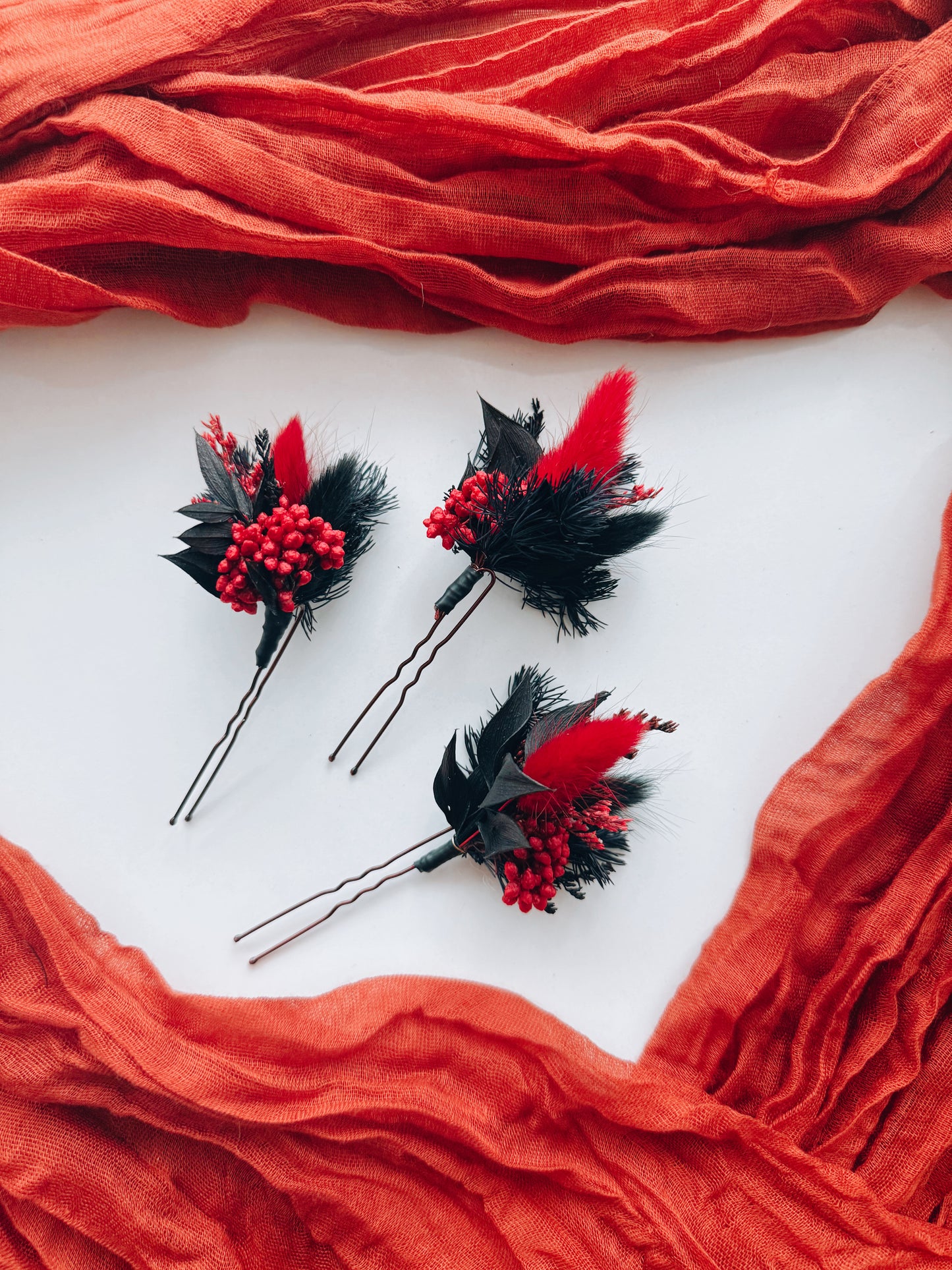 Rustic bridal hairstyle with handmade dried flower hairpins in red and burgundy tones. Unique wedding hair accessories for boho and autumn brides. Long-lasting floral design crafted in Australia.