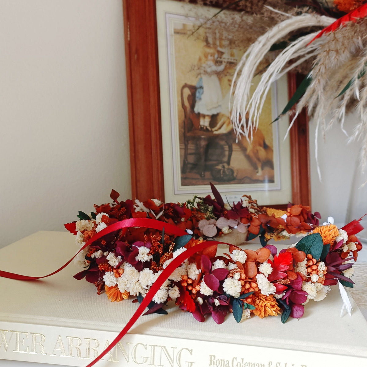 Rustic preserved flower crown in warm autumn colours with burgundy, orange, ivory and green dried flowers