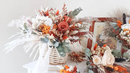 Collection of bespoke dried flower wedding accessories, including bouquets and boutonnieres. Crafted with care, these designs feature a mix of orange, beige, and green hues for a timeless look