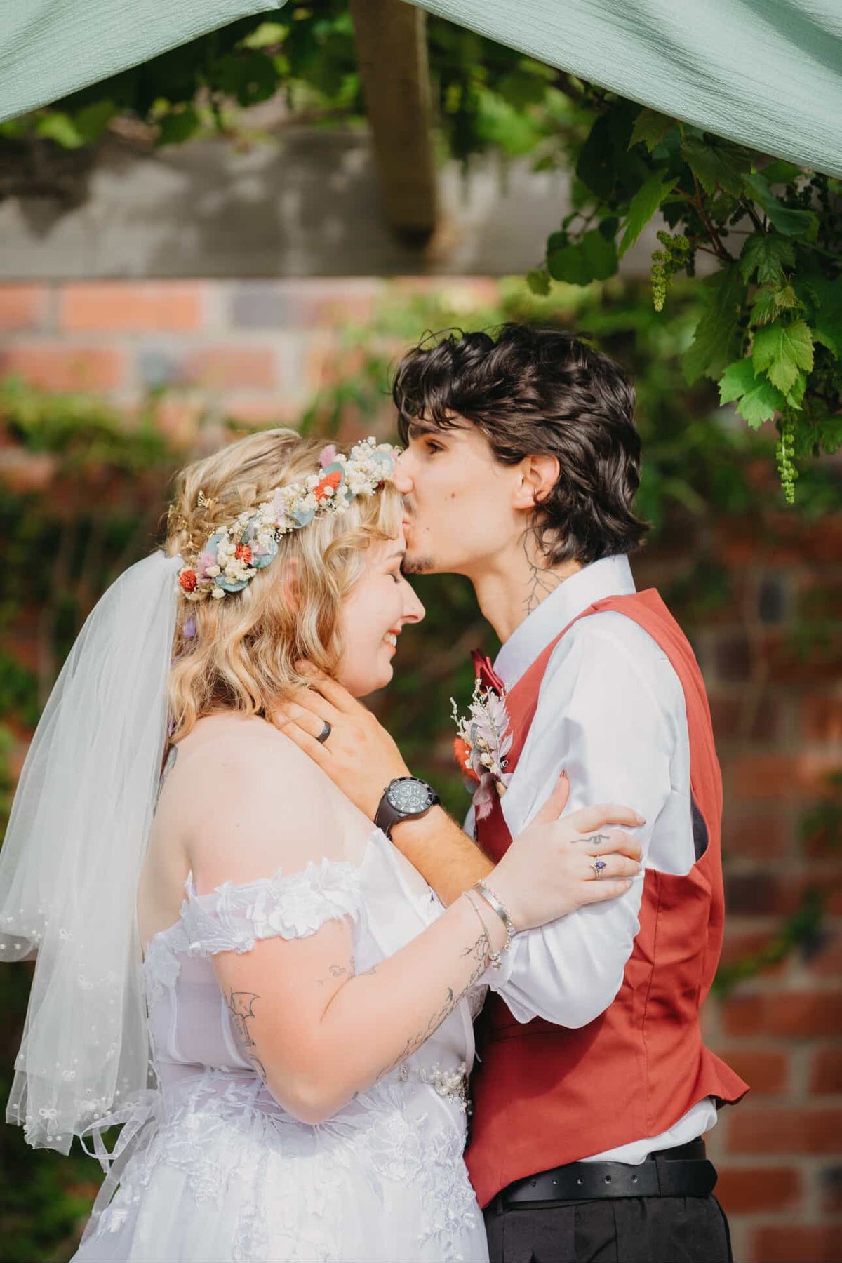 Bride wearing a colourful dried flower crown with her partner at a romantic outdoor wedding in Australia