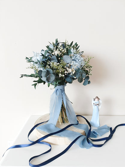 dusty blue wedding bouquet, blue and white bridal bouquet, soft blue floral arrangement, light blue preserved flowers, pastel blue bouquet, rustic blue wedding bouquet, boho blue bridal bouquet, elegant blue and white bouquet, romantic wedding bouquet, vintage-inspired bouquet, medium bridal bouquet, hand-tied wedding bouquet, loose organic bouquet, blue wedding theme, dusty blue wedding inspiration, rustic boho wedding flowers, elegant blue and white wedding, classic blue wedding bouquet