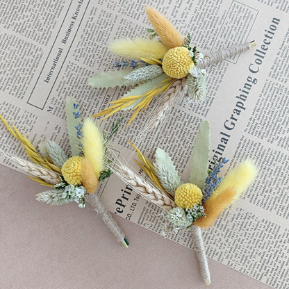 dried flower boutonnieres with yellow craspedia, bunny tails, and preserved foliage â€“ ideal for rustic or boho weddings and groomsmen