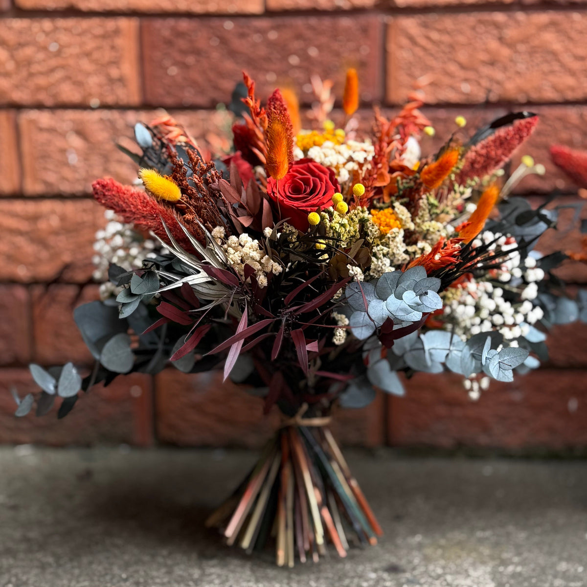 Bouquet of flowers in front of a brick wall