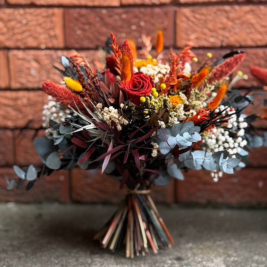 Bouquet of flowers in front of a brick wall