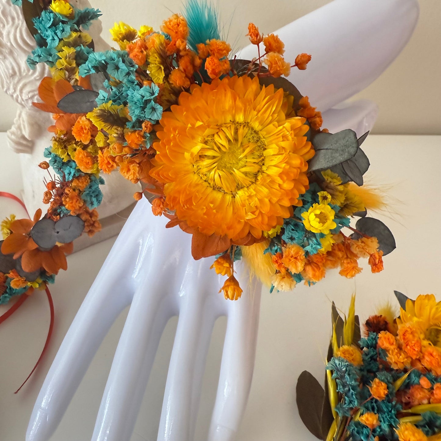 Sunflower wrist corsage with teal and burnt orange dried flowers for wedding