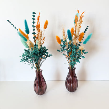 teal dried floral arrangements on a white background