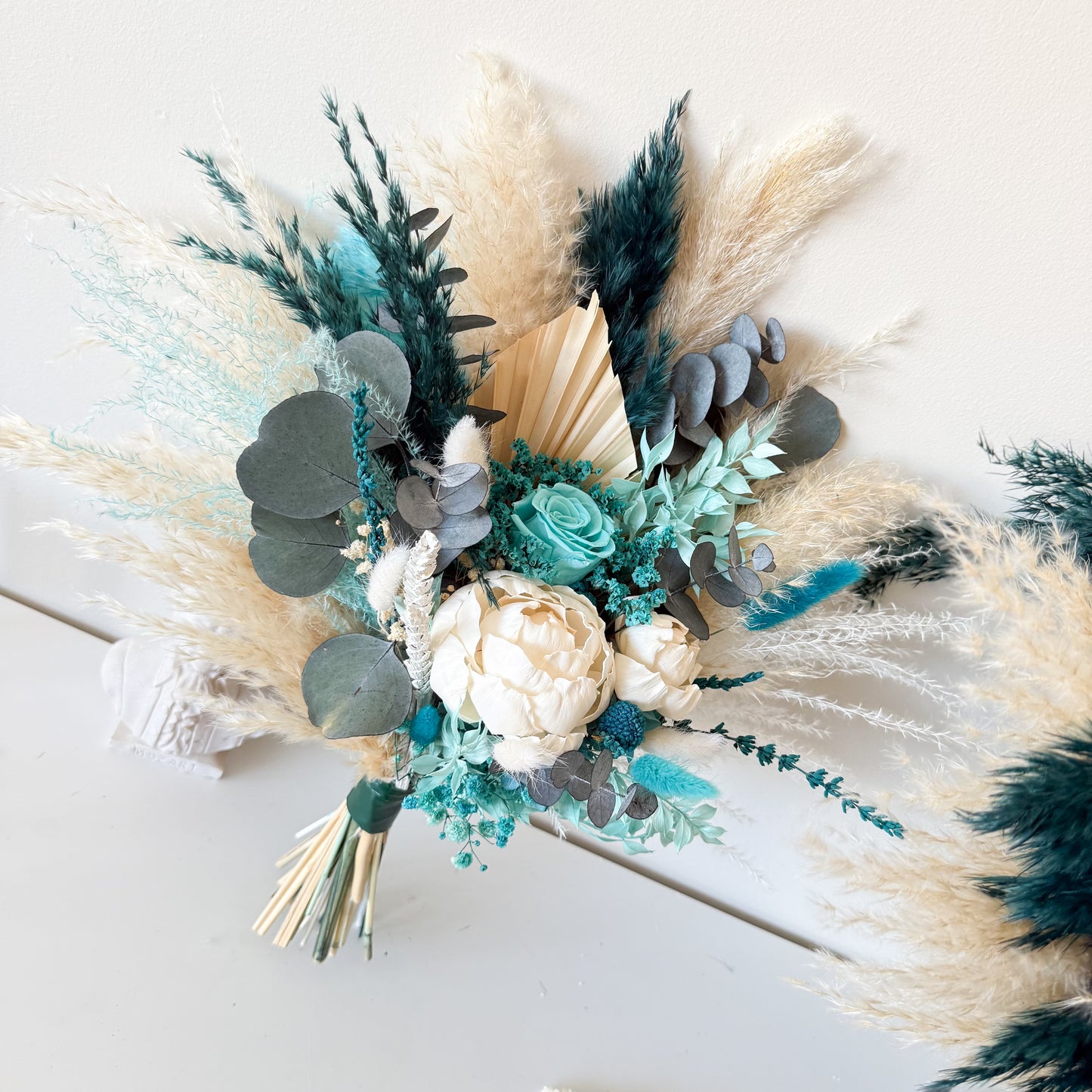 Teal boho bridal bouquet with dried and preserved flowers close up