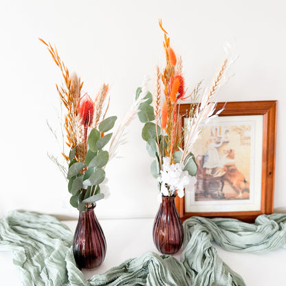 Set of two dried flower arrangements with orange bunny tails, eucalyptus, and white accents, perfect for boho home decor or wedding styling