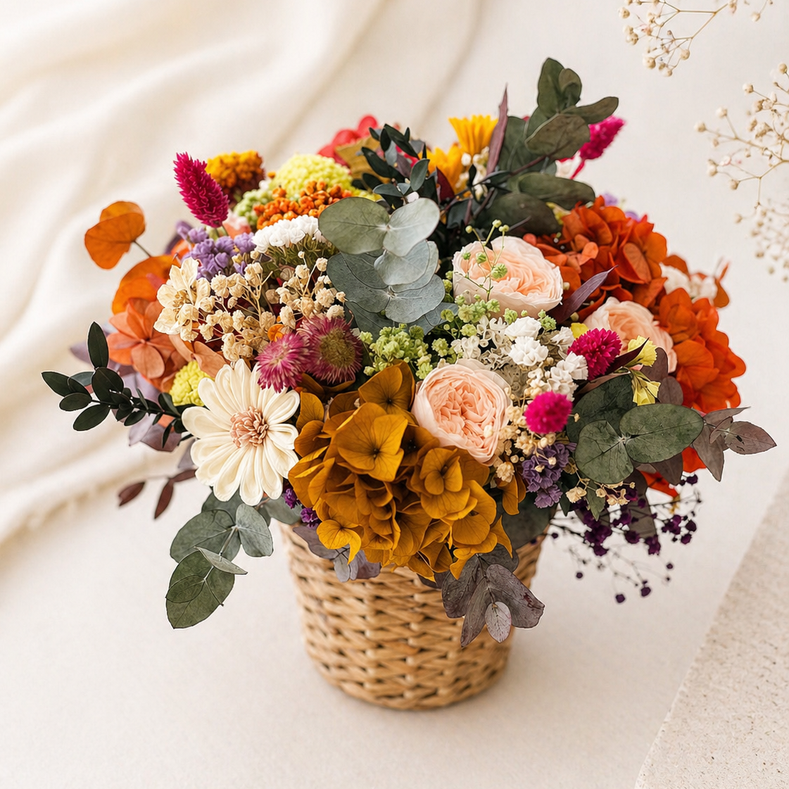 Colorful bouquet of flowers in a woven basket on a light background