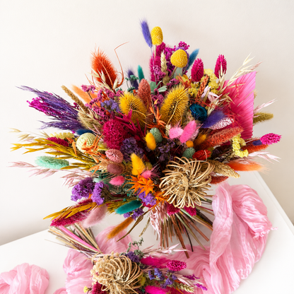 Close-up of a vibrant dried flower bridal bouquet with preserved botanicals, colourful grasses and everlasting flowers.