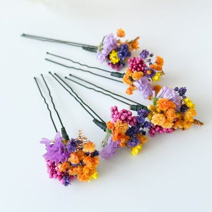 Dried flower hair pin detail in blonde hair, boho wedding hair accessory with purple and orange flowers