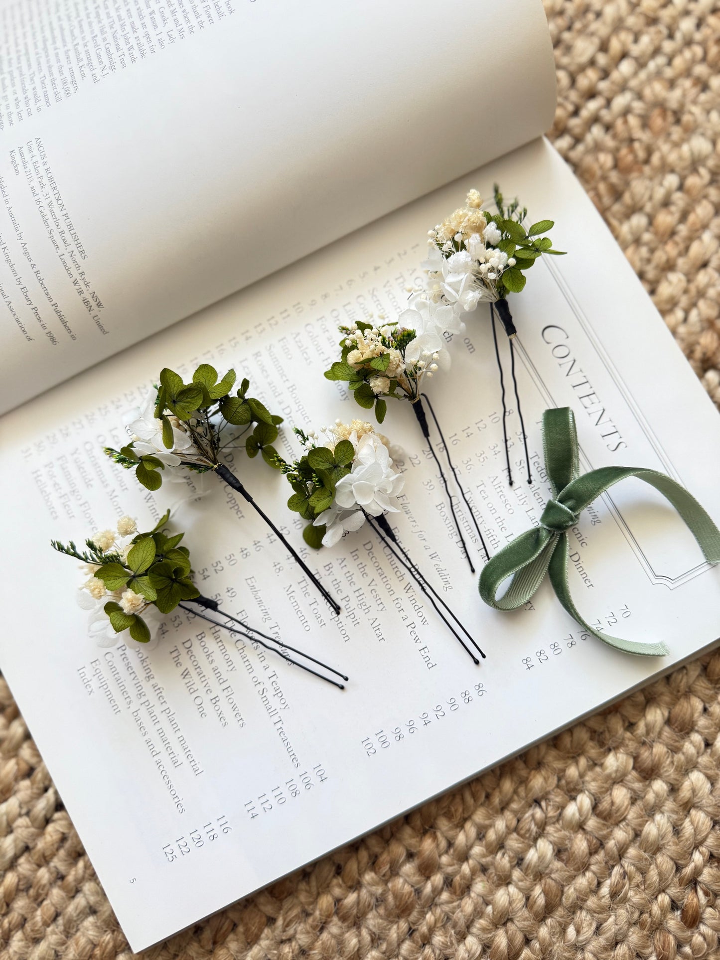White preserved flower bridal hair pins with greenery, styled for soft, natural, boho-inspired wedding hairstyles in Australia.